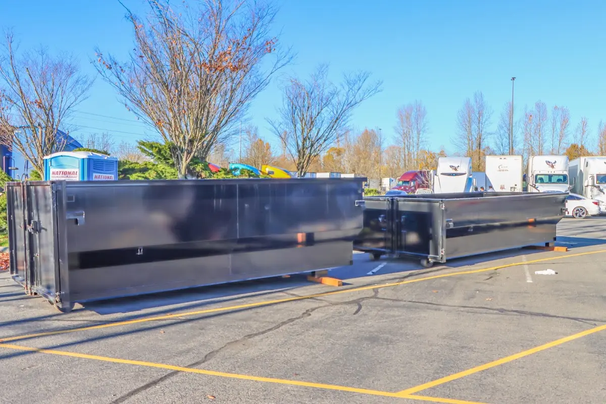 Professional dumpster rental service with roll-off container on residential driveway in Cocoa Beach